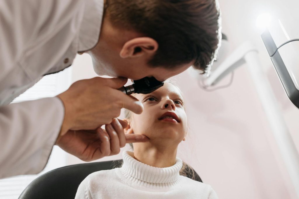 A Doctor Checking a Girl's Eye